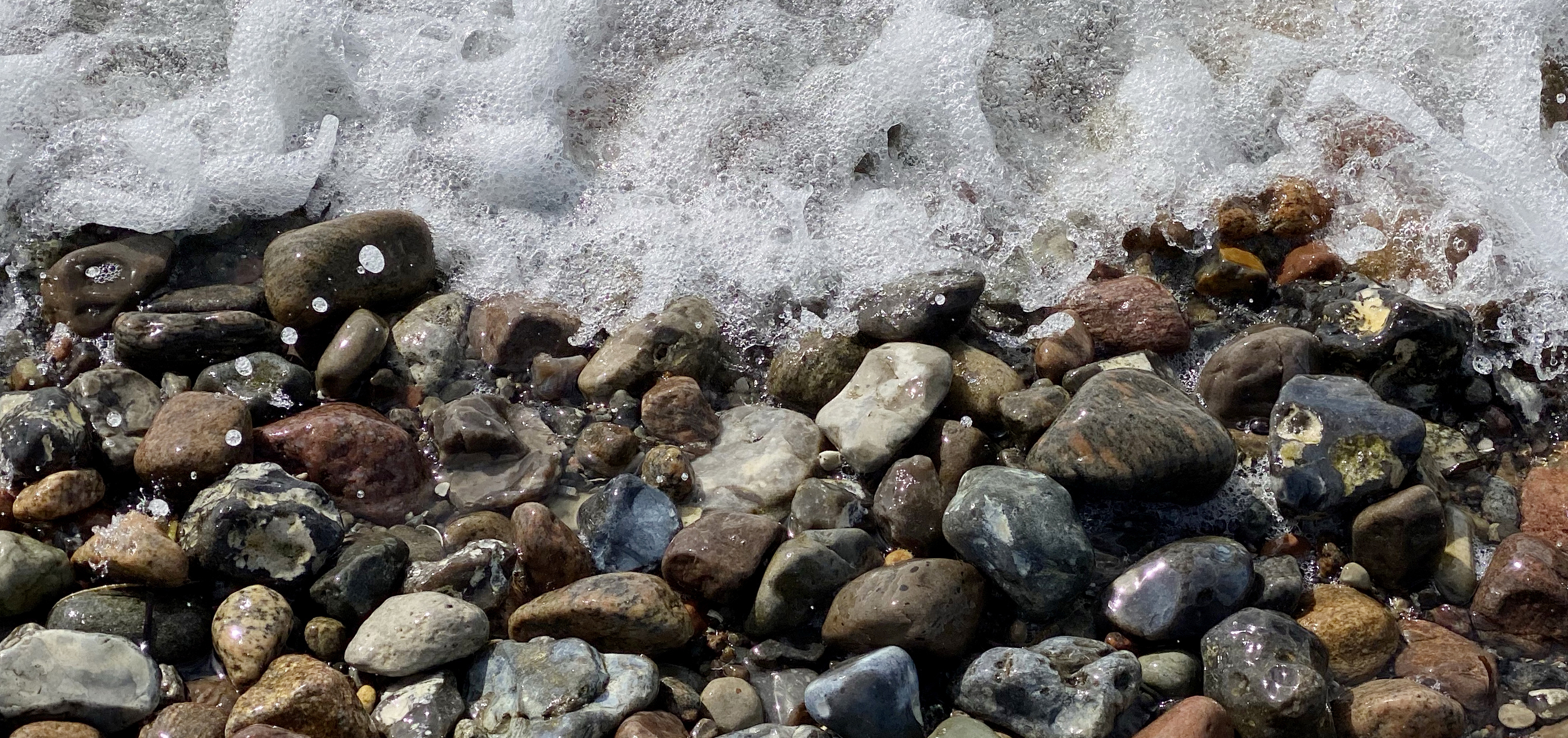 close-up of pebbles in shore break on the baltic coast in schleswig-holstein, germany